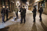 Police patrol the center of the city to enforce the curfew in Strasbourg, eastern France, Saturday, Oct. 24, 2020. The curfew imposed in eight regions of France last week, including Paris and its suburbs, is being extended to 38 more regions and Polynesia. (AP Photo/Jean-Francois Badias)