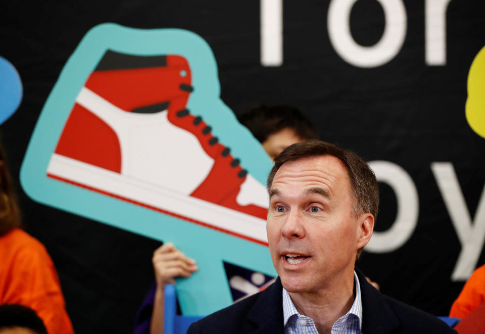 Canada's Finance Minister Bill Morneau speaks after he tried on a new pair of shoes during a pre-budget photo opportunity with children in Toronto, Ontario, Canada, March 14, 2019.  REUTERS/Mark Blinch