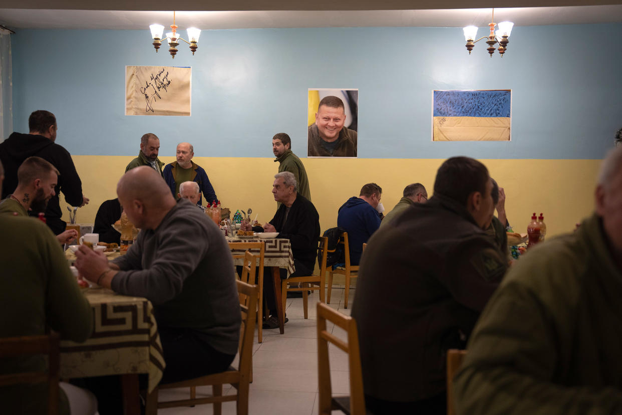 Wounded soldiers have lunch in a hospital in Ukraine on Wednesday, Dec. 20, 2023. A portrait of General Zaluzhny hangs in the background.<span class="copyright">Efrem Lukatsky—AP</span>