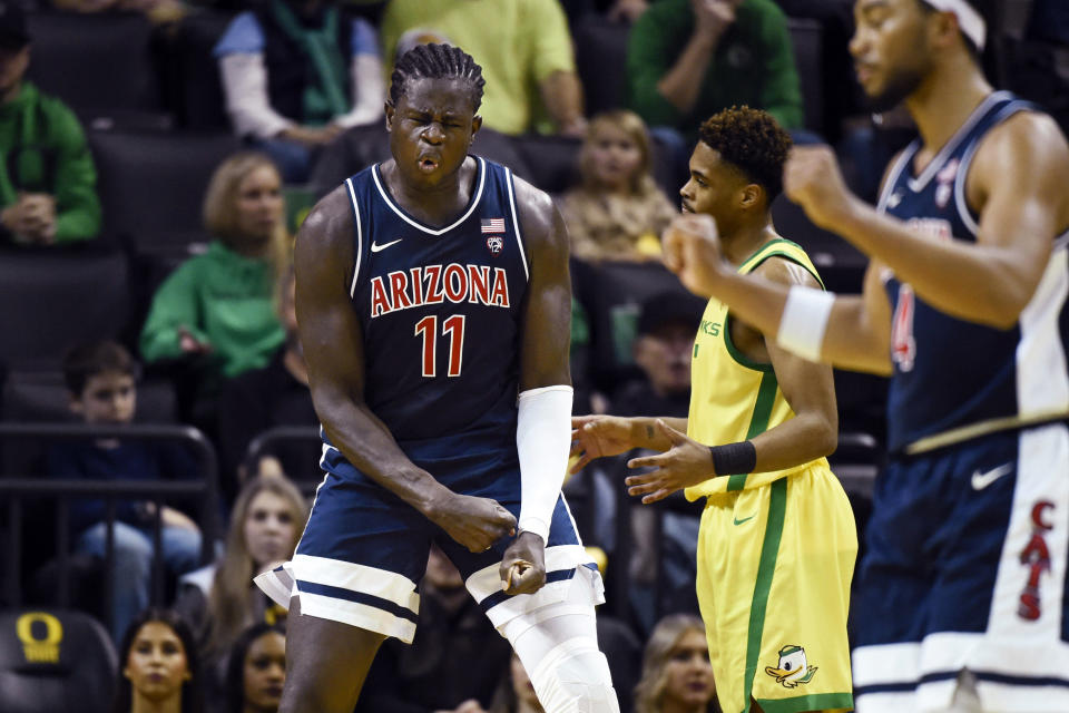 Arizona center Oumar Ballo (11) reacts after he was fouled on a shot as Oregon guard Keeshawn Barthelemy, right rear, reacts during the first half of an NCAA college basketball game Saturday, Jan. 14, 2023, in Eugene, Ore. (AP Photo/Andy Nelson)