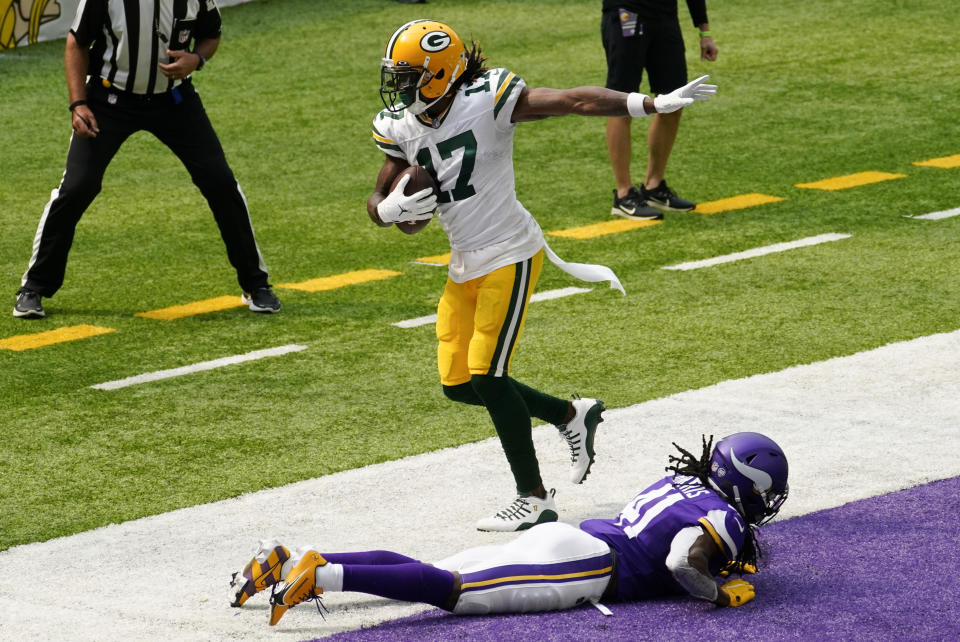 Green Bay Packers wide receiver Davante Adams (17) catches a 24-yard touchdown pass over Minnesota Vikings defensive back Anthony Harris during the first half of an NFL football game, Sunday, Sept. 13, 2020, in Minneapolis. (AP Photo/Jim Mone)