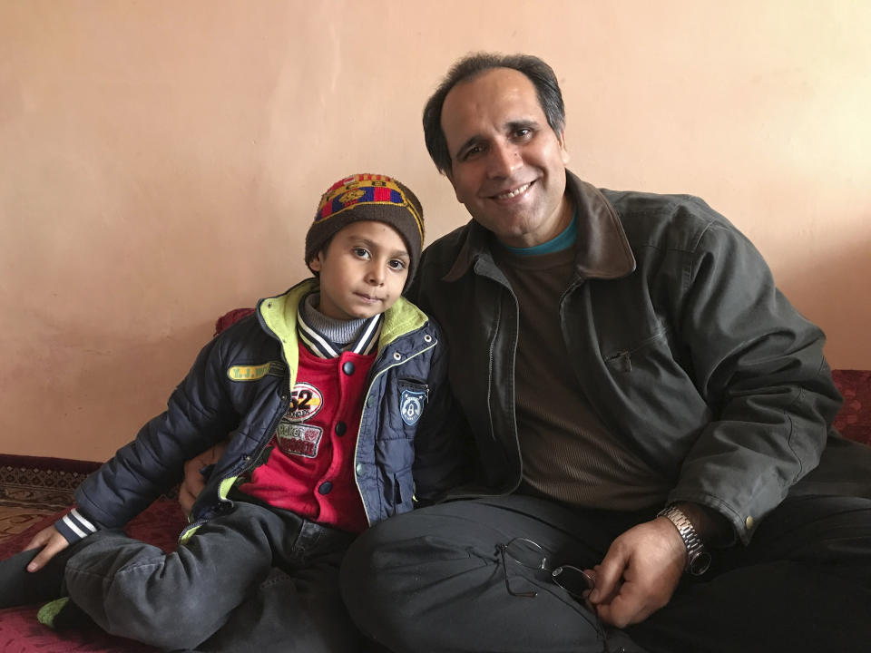 This photo provided by Bahaudin Mujtaba shows Noman Mujtaba, left, and Bahaudin Mujtaba in Kabul, Afghanistan, on Dec. 21, 2017. The boy, now 10 years old, is a distant relative of Mujtaba, who lives in Florida and is trying to adopt him and bring him to the United States. (Courtesy of Bahaudin Mujtaba via AP)