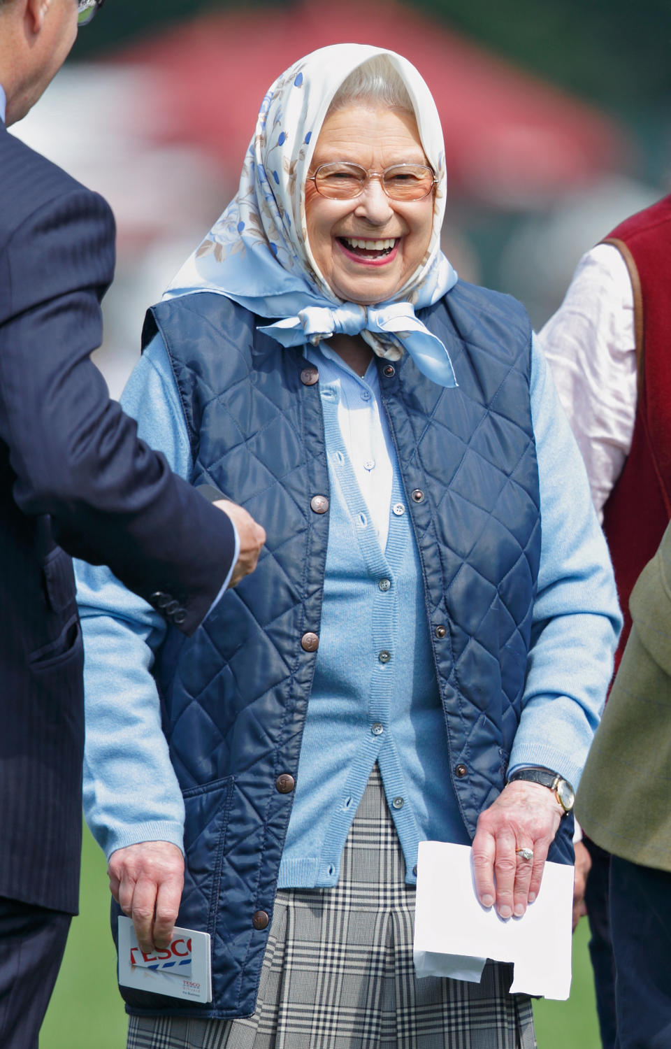 Queen Elizabeth II laughs as she receives a Tesco Gift Card as a prize after her horse 'Barber's Shop' won the Tattersalls and RoR Thoroughbred Ridden Show Series Championship on day 2 of the Royal Windsor Horse Show in Home Park on May 12, 2016 in Windsor, England. (Photo by Max Mumby/Indigo/Getty Images)