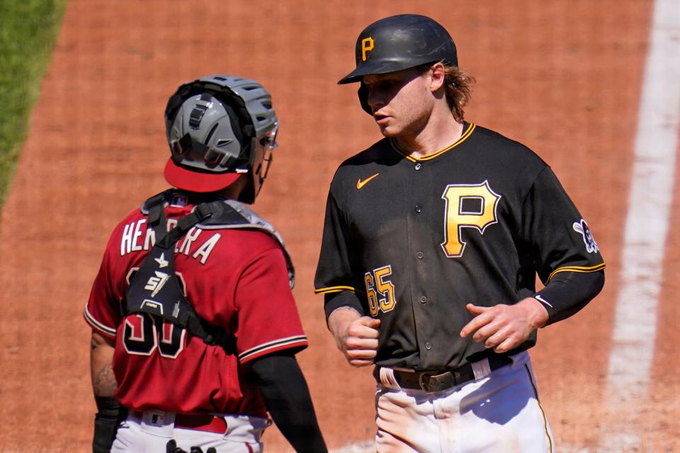 Pittsburgh Pirates' Jack Suwinski, right, scores past Arizona Diamondbacks catcher Jose Herrera on a single by Ke'Bryan Hayes during the seventh inning of a baseball game in Pittsburgh, Sunday, June 5, 2022. (AP Photo/Gene J. Puskar)