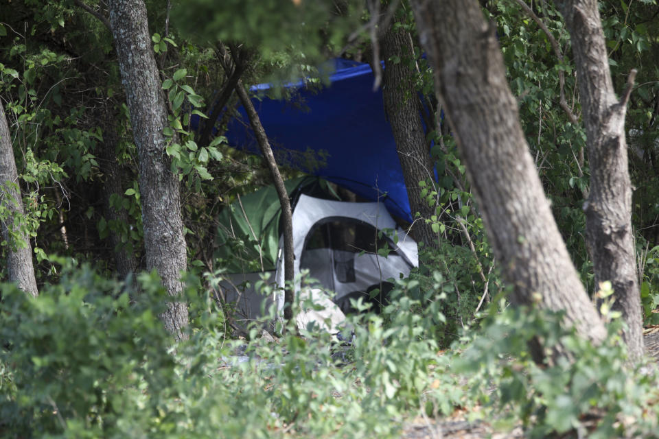 A tent sits in a grove of trees on a wooded lot amid businesses in Topeka, Kan., Thursday, Oct. 5, 2023. Neighbors suspect Zoey Felix, 5, Mickel Cherry and Zoey's father were living there, although police haven’t confirmed that. Cherry, a homeless man, has been charged with the murder and rape of Felix and could face the death penalty in connection with the girl's death on Monday, Oct. 2. (AP Photo/John Hanna)