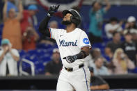 Miami Marlins' Bryan De La Cruz (14) gestures after hitting a home run during the ninth inning of a baseball game against the Los Angeles Angels, Tuesday, April 2, 2024, in Miami. (AP Photo/Marta Lavandier)