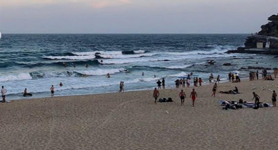 Beachgoers watch on as the group of fast-acting rescuers drag them from the water. Source: Instagram/Bronte Surf Club