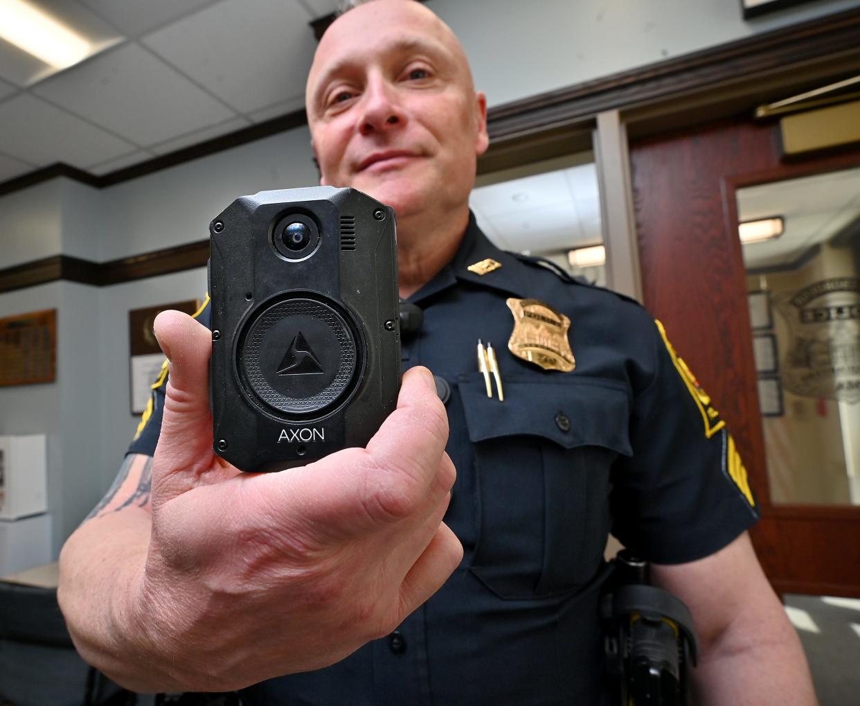 Westborough police Sgt. Todd Rossi shows the body camera normally attached to his uniform.