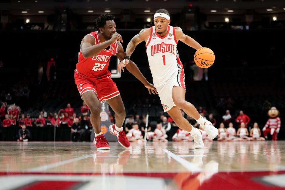 Mar 19, 2024; Columbus, OH, USA; Ohio State Buckeyes guard Roddy Gayle Jr. (1) dribbles past Cornell Big Red forward DJ Nix (23) during the first half of the NIT basketball game at Value City Arena.