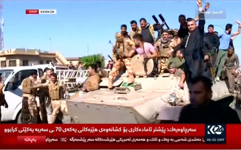 Kurdish forces on an armoured vehicle drive in the street of Kirkuk, Iraq, October 16, 2017, in this still image taken from a video.  - Credit:  KURDISTAN 24 TV via REUTERS TV