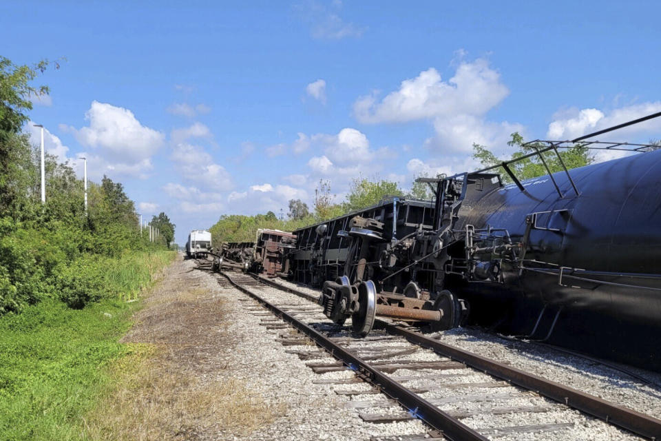 This photo provided by the Manatee County Government shows a derailed freight train operated by Seminole Gulf Railway near Bradenton, Fla., on Tuesday, Feb. 28, 2023. Officials in Florida are keeping a watchful eye on a train car carrying 30,000 gallons (113,562 liters) of propane that tipped over in a derailment in an industrial area near Sarasota Bradenton International Airport. (Steve Litschauer/Manatee County Government via AP)
