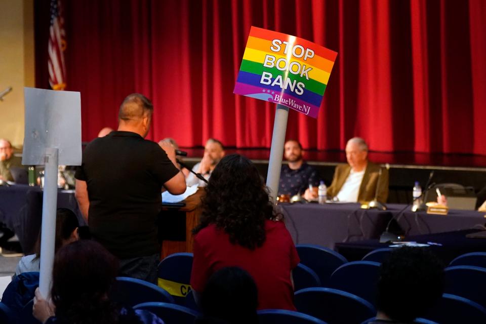 One person protesting the banning of the books in question holds a sign reading, "Stop book bans," during the public comment portion of the Roxbury board of education meeting on Monday, June 12, 2023. 