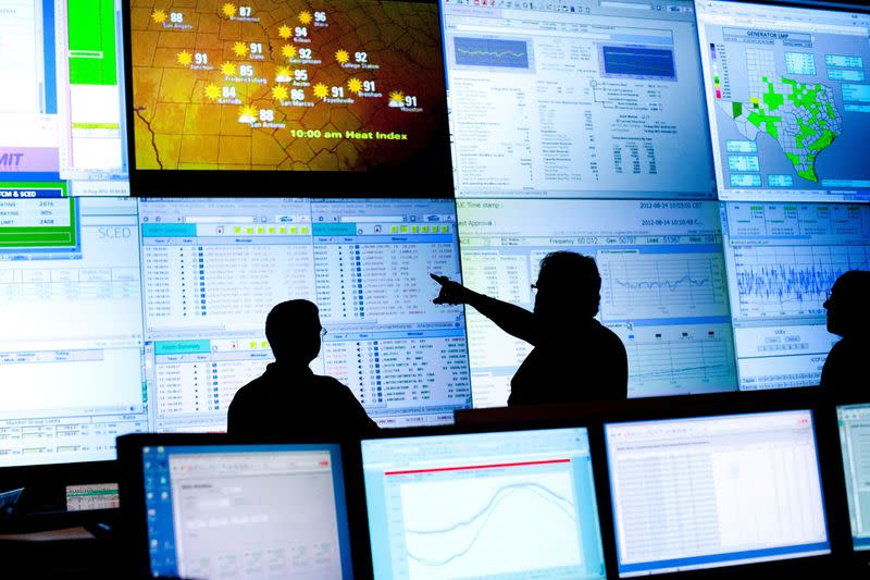 FILE PHOTO: Reliability coordinators monitor the state power grid during a tour of the Electric Reliability Council of Texas (ERCOT) command center in Taylor