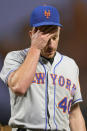 New York Mets starting pitcher Chris Bassitt rubs his head while walking off the field after being removed during the fifth inning of the team's baseball game against the San Francisco Giants in San Francisco, Tuesday, May 24, 2022. (AP Photo/Tony Avelar)