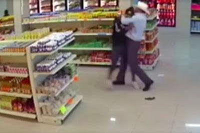 Shocking moment 'cowboy' tackles armed robber in supermarket