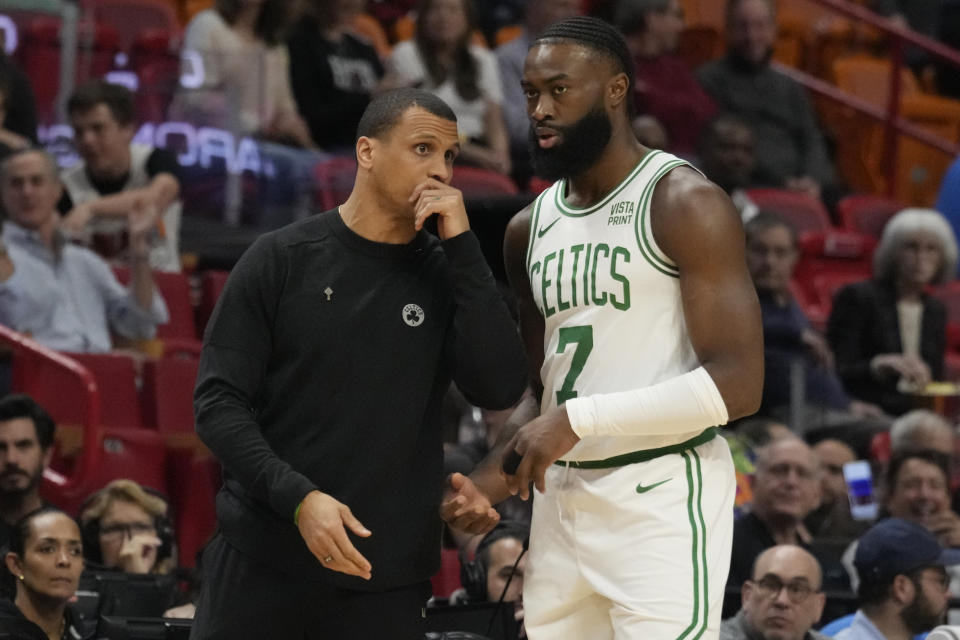 Boston Celtics head coach Joe Mazzulla talks to guard Jaylen Brown (7) during the first half of an NBA basketball game, Thursday, Jan. 25, 2024, in Miami. (AP Photo/Marta Lavandier)