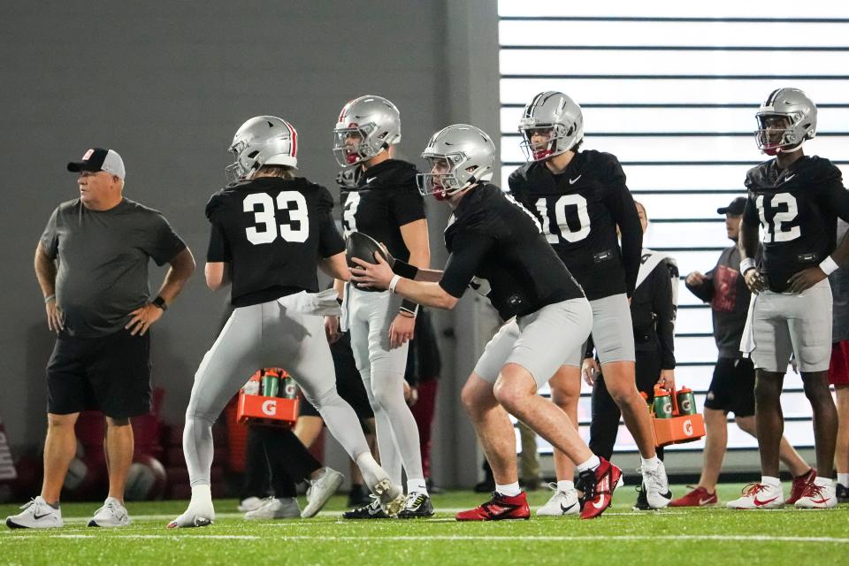 Mar 7, 2024; Columbus, OH, USA; Ohio State Buckeyes quarterbacks Devin Brown (33) and Will Howard (18) take snaps during spring football practice at the Woody Hayes Athletic Center.