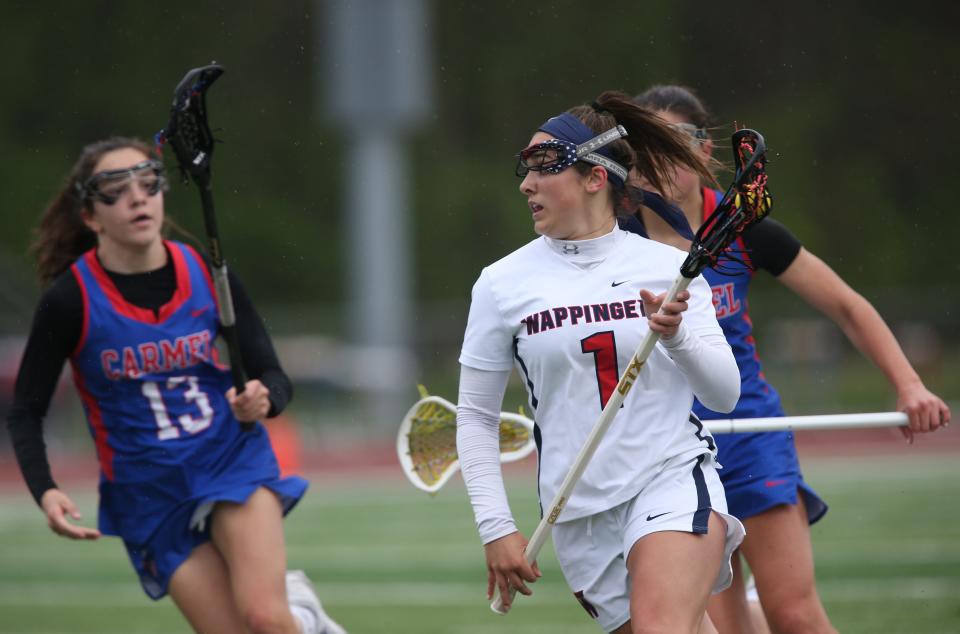 Wappingers' Nicolette Diedrich closes in on the goal as Carmel's Taylor Lotz covers her during Friday's game on May 6, 2022.