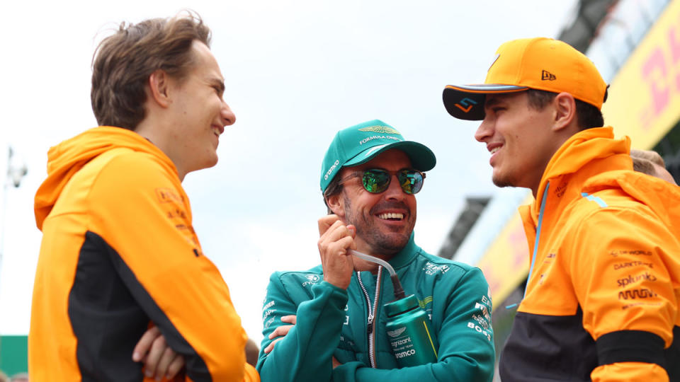 McLaren's 23-year-old Oscar Piastri (left) and 24-year-old Lando Norris (right), share a laugh with Aston Martin's 42-year-old Fernando Alonso.