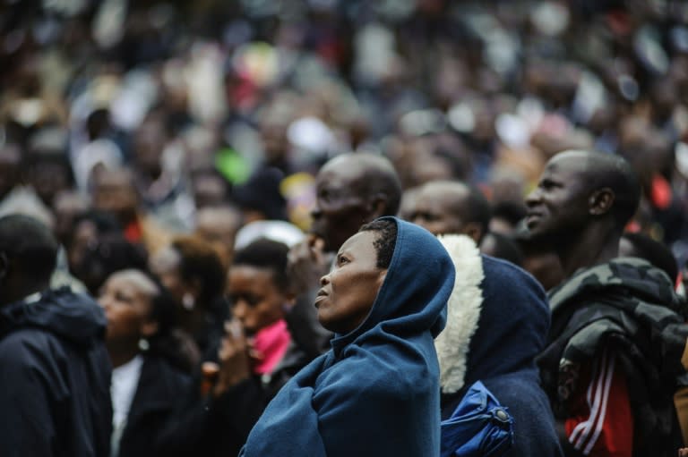 Kenyans listen to Pope Francis's holy mass via live CCTV on November 26, 2015 in Central Park in Nairobi