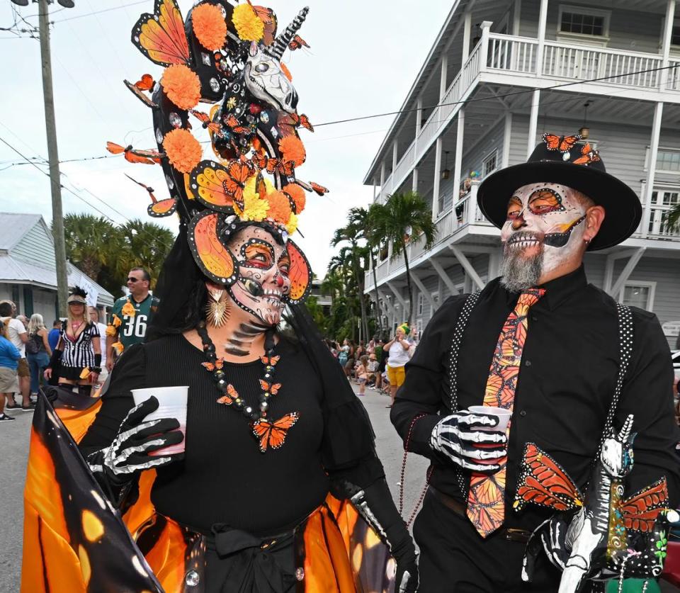 Two costumed revelers proceed down Fleming Street in Key West Friday, Oct. 27, 2023, during the Captain Morgan Masquerade March.