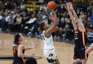 Colorado guard Mikayla Johnson, center, drives to the basket between Oregon State guard AJ Marotte, left, and forward Kelsey Rees, right, in the second half of an NCAA college basketball game Sunday, Feb. 11, 2024, in Boulder, Colo. (AP Photo/David Zalubowski)