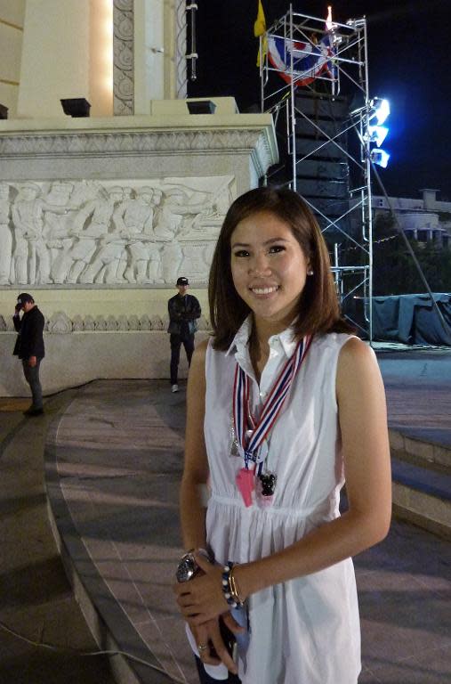 27-year-old Chitpas Bhirombhakdi, a former Democrat Party spokeswoman, poses for a photo near one the main anti-government rally sites in Bangkok, on December 12, 2013