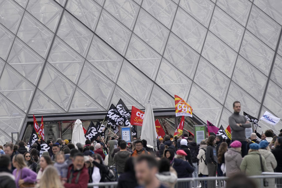 Workers of the culture industry demonstrate outside the Louvre museum Monday, March 27, 2023 in Paris. President Emmanuel Macron inflamed public anger by sending his already unpopular plan to raise the retirement age by two years, from 62 to 64, through parliament without a vote. (AP Photo/Christophe Ena)