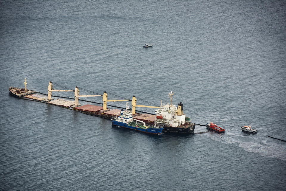 The Tuvalu-registered OS 35 cargo ship that collided with a liquid natural gas carrier in the bay of Gibraltar last Monday, lies on the seabed, off Catalan bay to prevent it from sinking in Gibraltar, Thursday, Sept. 1, 2022. Gibraltar authorities say that a small amount of heavy fuel oil has leaked from a bulk carrier ship stranded since colliding Monday with another ship near the Bay of Gibraltar. A government spokesman said that the situation was under control and the cargo ship was not in danger. He said there has been no environmental impact so far. (AP Photo/Marcos Moreno)