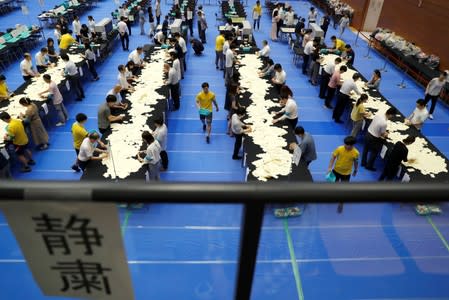 Election officers count votes at a ballot counting centre for Japan's upper house election in Tokyo