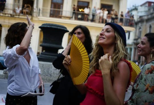 Gisele Bundchen fans herself prior to the fashion show. (Photo: AP)