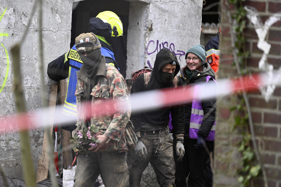 Five days after the eviction of Luetzerath began, two remaining climate activists leave an underground tunnel under a building in Luetzerath, Germany, Monday, Jan. 16, 2023. (Roberto Pfeil/dpa via AP)