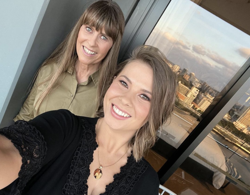 Bindi Irwin wears a necklace with a photo of Steve Irwin on the pendant as she poses for a selfie with mum Terri.