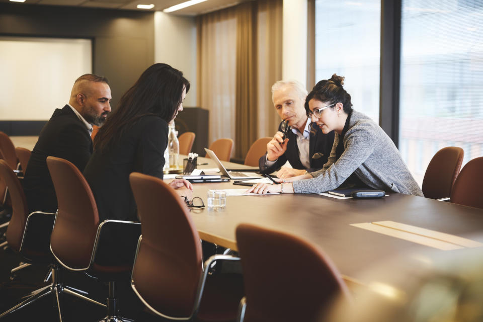 people sitting at a conference table