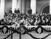 Warren G. Harding, center right, takes the oath of office administered by Chief Justice Edward D. White on the East Portico of the Capitol building in Washington, D.C., March 4, 1921. (AP Photo)