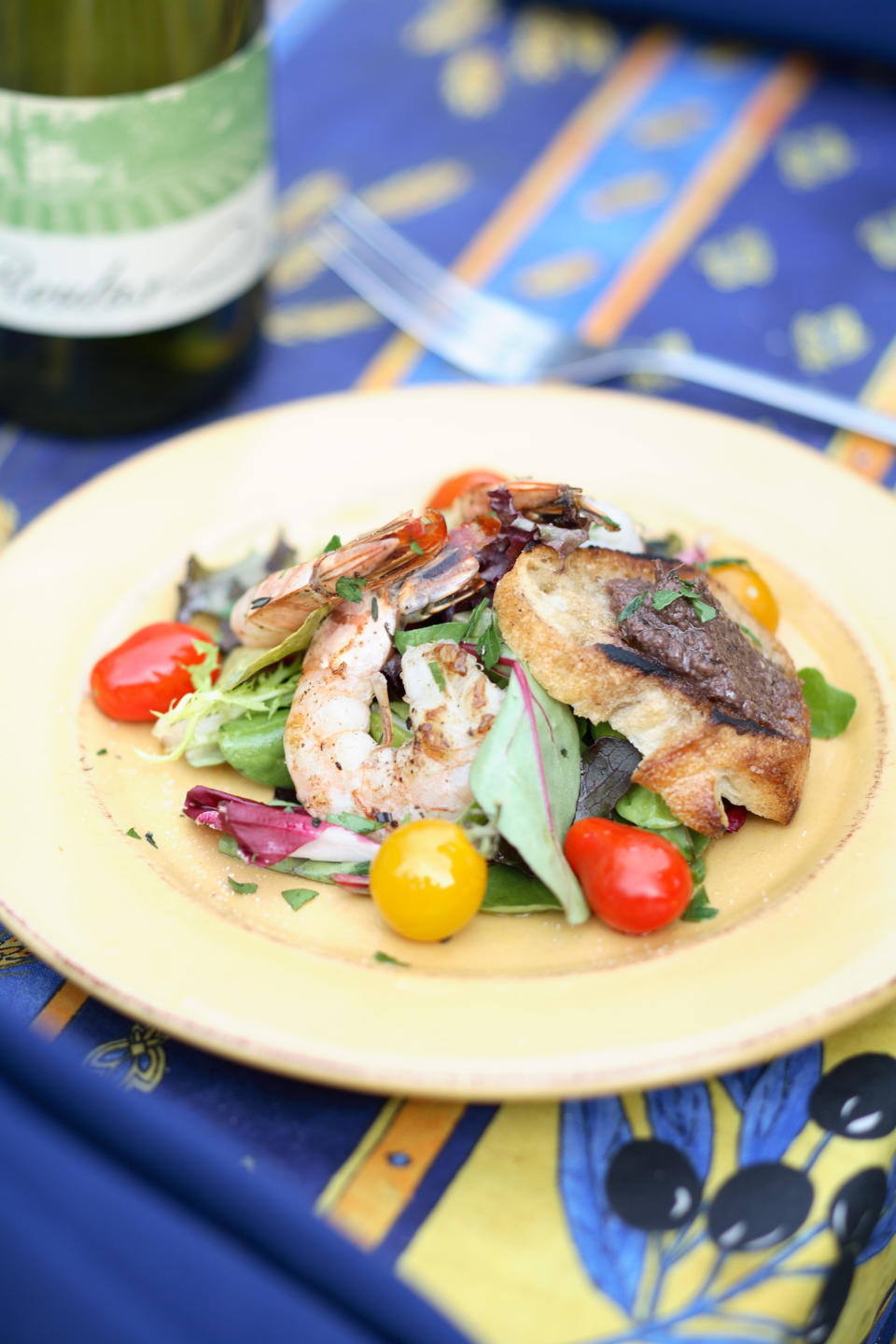 This undated photo released by Far and Away Adventures shows a gourmet shrimp salad on a "glamping" _ glamour camping _ expedition on the Middle Fork of Idaho's Salmon River, also known as the River of No Return. Participants go whitewater rafting and sleep in tents, but they also dine on elegant meals served on linen tablecloths with wine, and yoga sessions and massages are provided. (AP Photo/Far and Away Adventures)