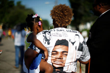 People participate in the funeral procession for Muhammad Ali outside Ali's childhood home. REUTERS/Lucy Nicholson