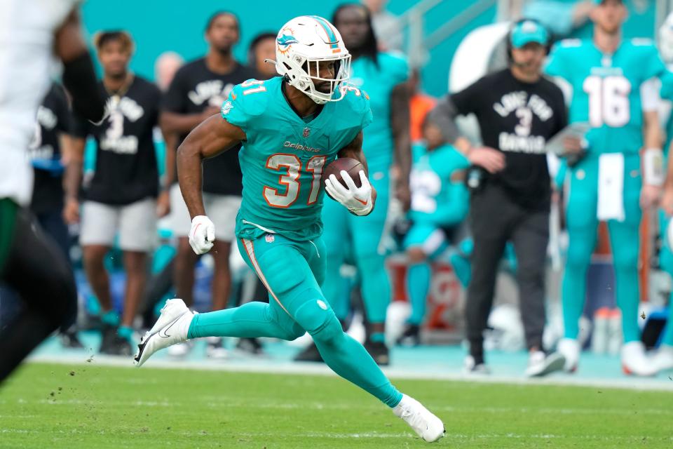 Miami Dolphins running back Raheem Mostert (31) runs during the second half of an NFL football game against the New York Jets, Sunday, Jan. 8, 2023, in Miami Gardens, Fla. (AP Photo/Lynne Sladky)