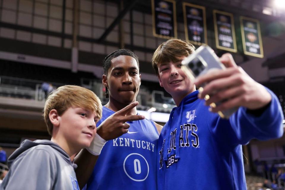 Kentucky guard Rob Dillingham takes a photo with fans after the Blue-White Game at Truist Arena in Highland Heights on Saturday.