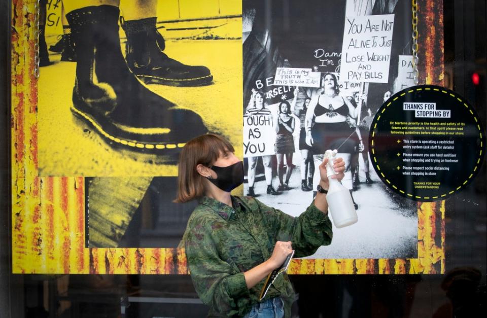 A member of staff at the Dr Martens shop in Edinburgh’s Princes Street (Jane Barlow/PA) (PA Archive)