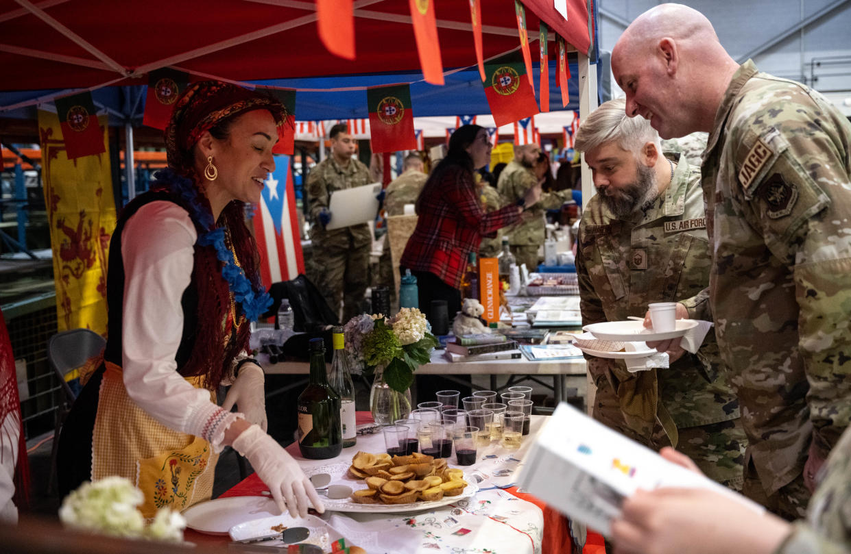 A representative of Portugal shows native dishes of the country during the 3rd Annual Pope World Tour at Pope Army Airfield.