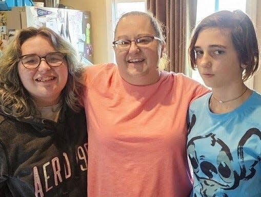 Zella Saunders, center, and her two daughters used to be among the unhoused in Gainesville. The family received an early Christmas gift when they received the news they were going to be tenants of a fully furnished luxury apartment in downtown Gainesville. (Photo courtesy of Gainesville Housing Authority)
(Credit: Gainesville Housing Authority)