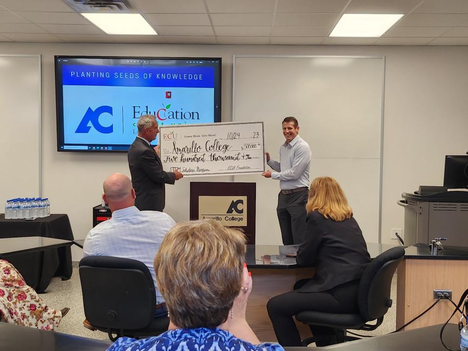 ECU CEO/President and ECU Foundation Board President Marcus Smith presents the $500,000 STEM scholarship endowment to Amarillo College's (AC) Vice President of Institutional Advancement, Joe Bill Sherrod, at a check presentation Tuesday afternoon in newly named ECU Foundation STEM Lab in the AC STEM Research Center.