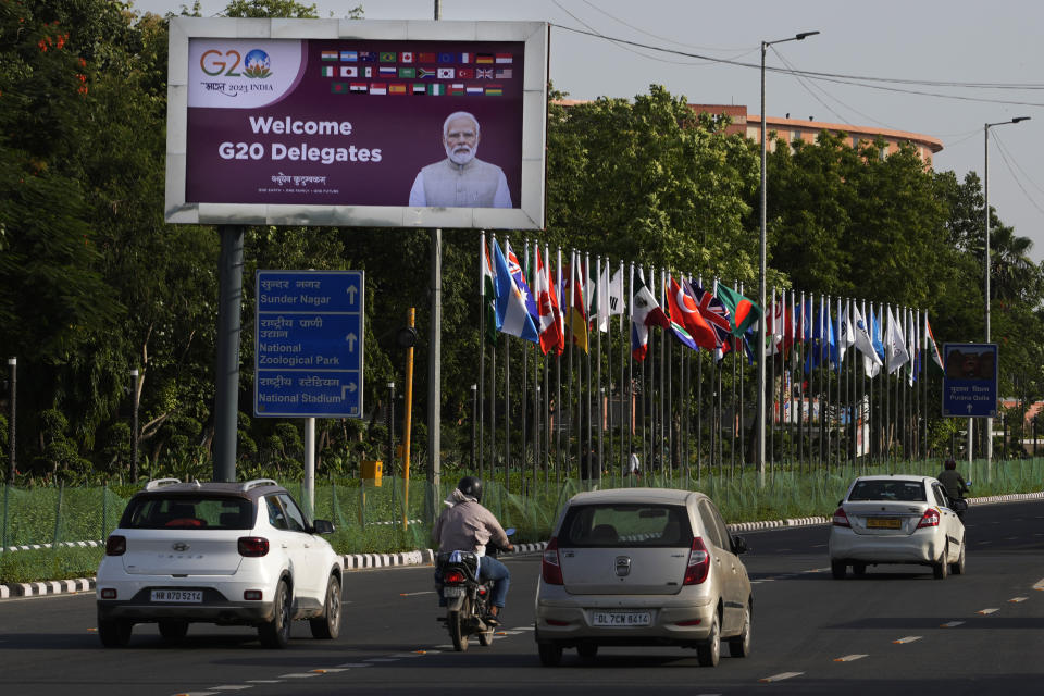 Traffic moves past a billboard featuring Indian Prime Minister Narendra Modi welcoming delegates ahead of this week's summit of the Group of 20 nations in New Delhi, India, Monday, Sept. 4, 2023. Major roads in New Delhi are teeming with giant posters and billboards announcing India's presidency of this week's summit of the Group of 20 nations. And one leader's picture smiling benignly from every traffic circle stands out from the rest: Prime Minister Narendra Modi. (AP Photo/Manish Swarup)