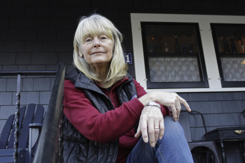 Susan Crowley, a 75-year-old retired attorney, sits outside her home in Hood River, Ore., on Jan. 23, 2021. Crowley submitted public comments to Oregon's vaccine advisory committee to criticize the state's controversial decision to vaccinate its teachers and early childhood care givers ahead of its oldest residents. Teachers in Oregon are eligible for the vaccine this week, two weeks ahead of the state's oldest residents and more than a month ahead of those between age 65 and 70. Oregon's decision underscores the difficult moral dilemma facing local and state public health officials as they weigh which populations need the vaccine most urgently amid a nationwide dose shortage. (AP Photo/Gillian Flaccus)