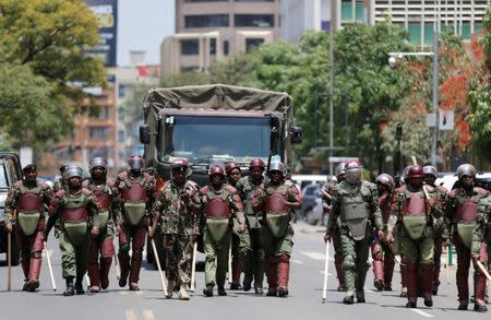 Riot policemen walk along a street in an attempt to disperse supporters of Kenyan opposition National Super Alliance (NASA) coalition, during a protest along a street in Nairobi, Kenya October 16, 2017. REUTERS/Thomas Mukoya