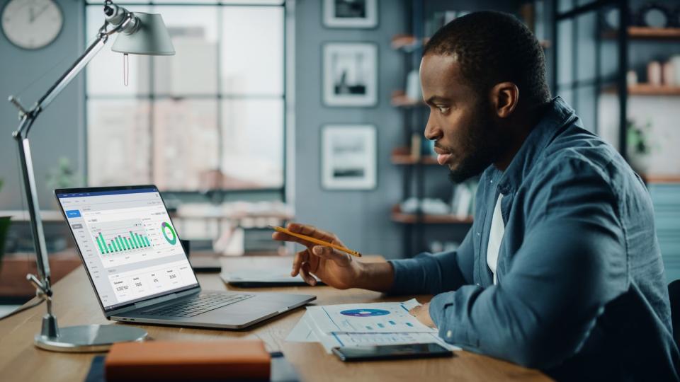 Attentive investor looks at stock charts.