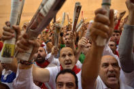 <p>Revellers hold newspapers as they sing a song to San Fermin on Santo Domingo street ahead of the first running of the bulls at the San Fermin Festival, in Pamplona, northern Spain, July 7, 2017. (Alvaro Barrientos/AP) </p>