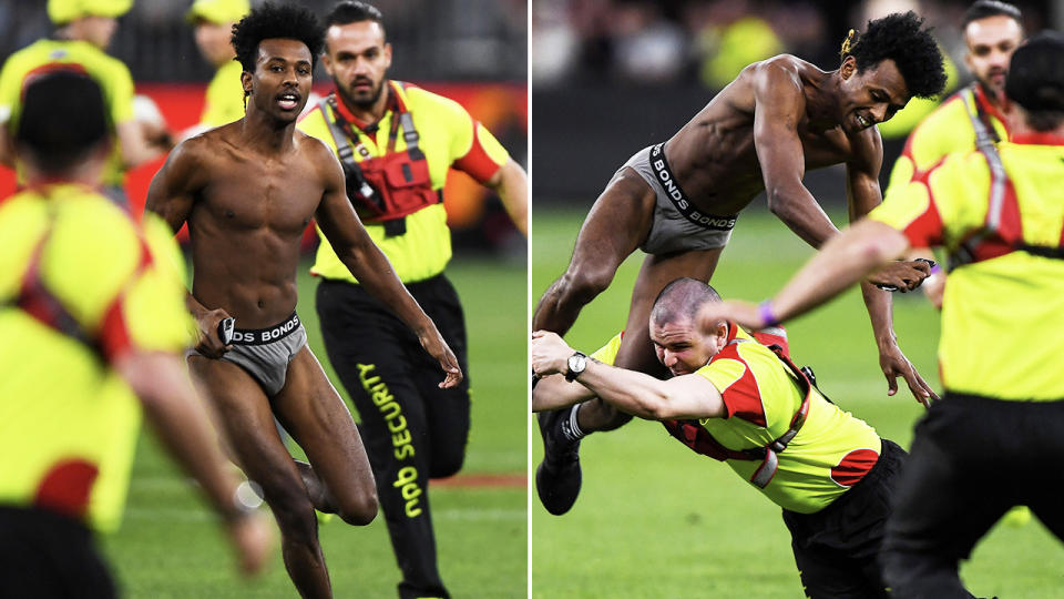 The pitch invader, pictured here being taken down by security guards at Optus Stadium.