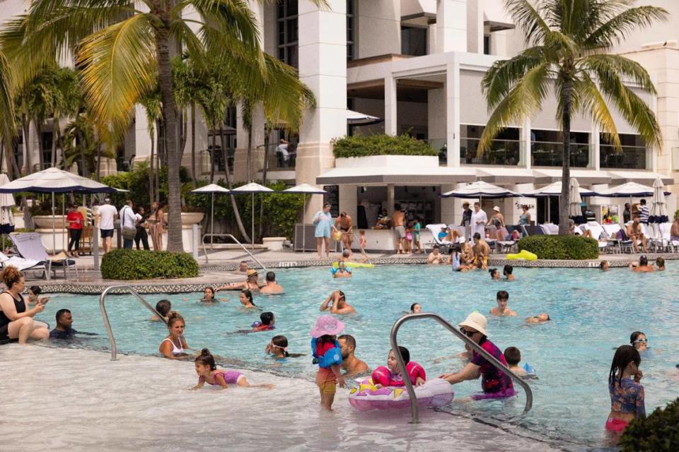 Guests at the Loews Miami Beach Hotel swim in the pool on Aug. 17, 2023.